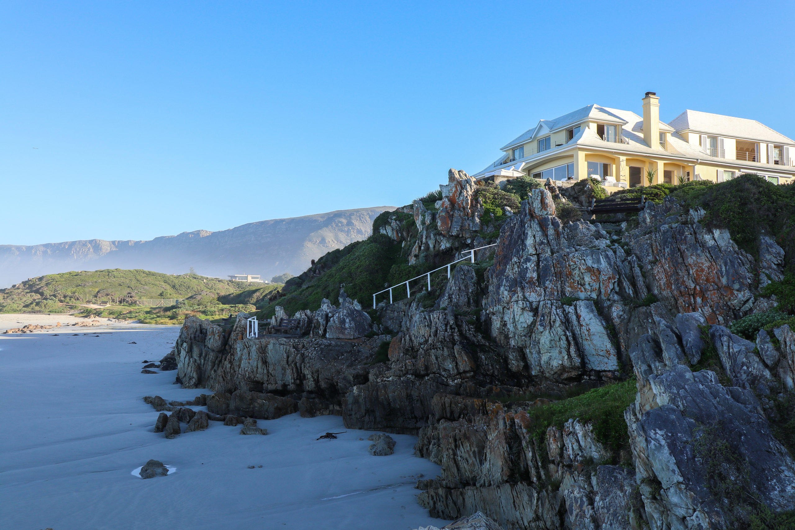 Birkenhead House perched on the rocks overlooking Walker Bay