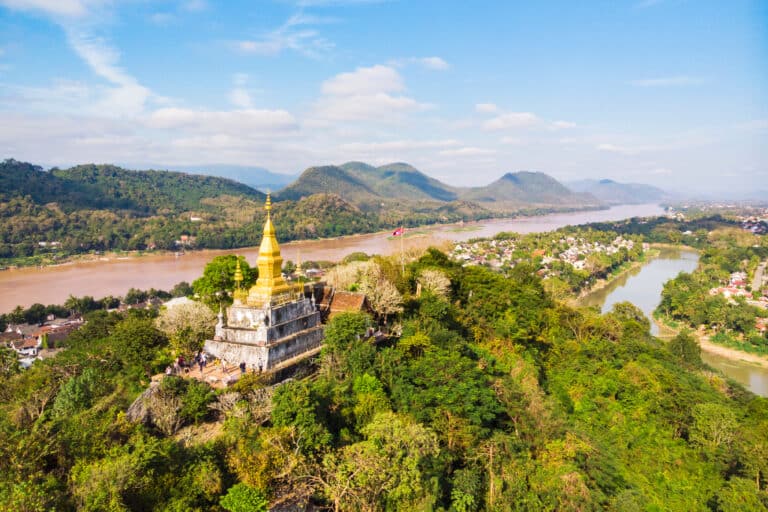 Climb Phousi Hill to Wat Chom Si's golden spire - Laos